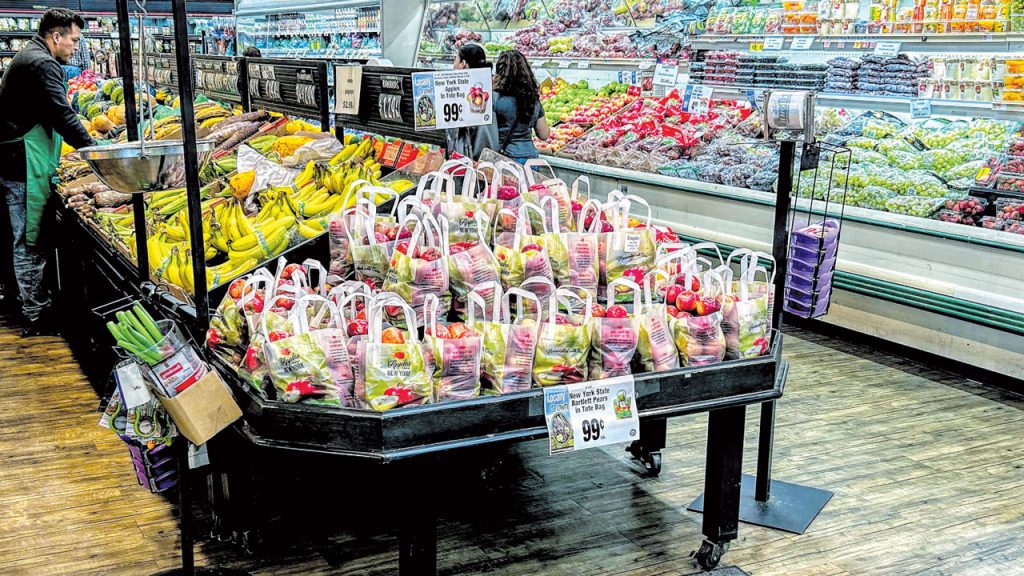 The floor displays in the produce department of Super Foodtown in the Bronx lead with packages of potatoes and tote-bag apples and pears identified as produced in New York.