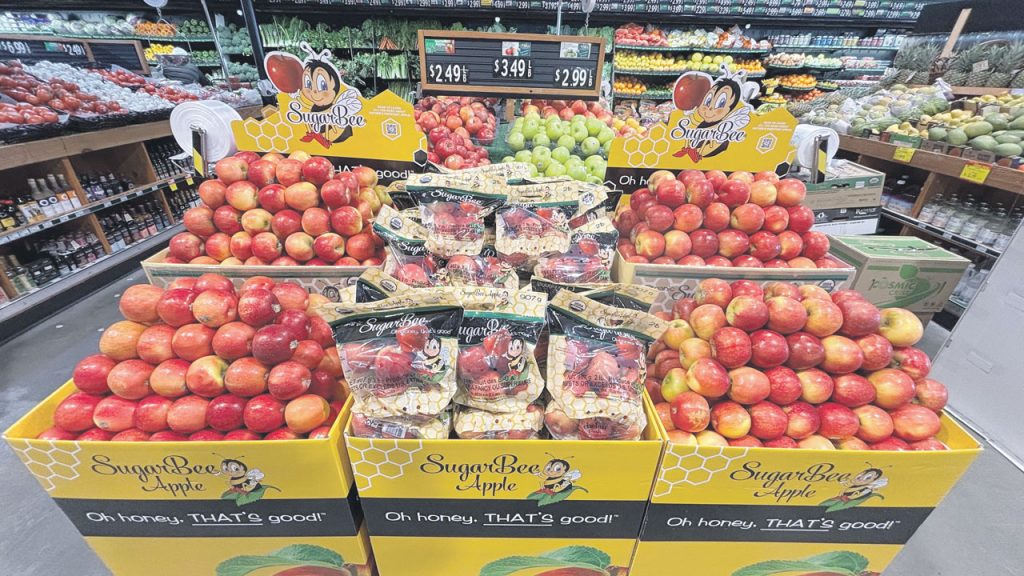Four Seasons Produce in Ephrata, PA, can help retailers with the right grades, sizes, variety, price points, attributes, and merchandising strategies for products. This photo shows a SugarBee Apple display at Nanuet, NJ, A Matter of Health, store.