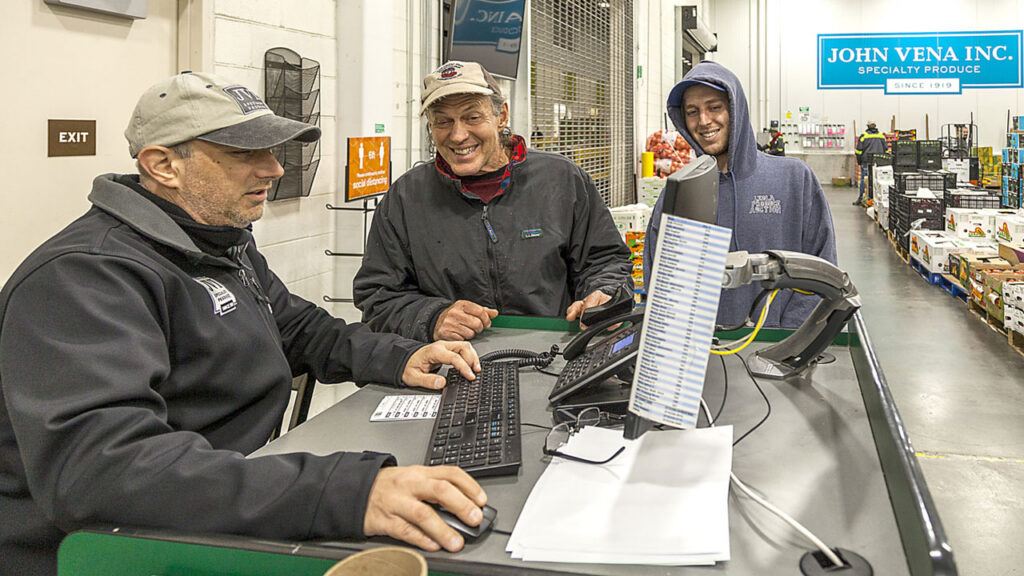 John Vena Inc. (JVI), Philadelphia, PA, sales and buying team, helps customers at JVI’s market store.