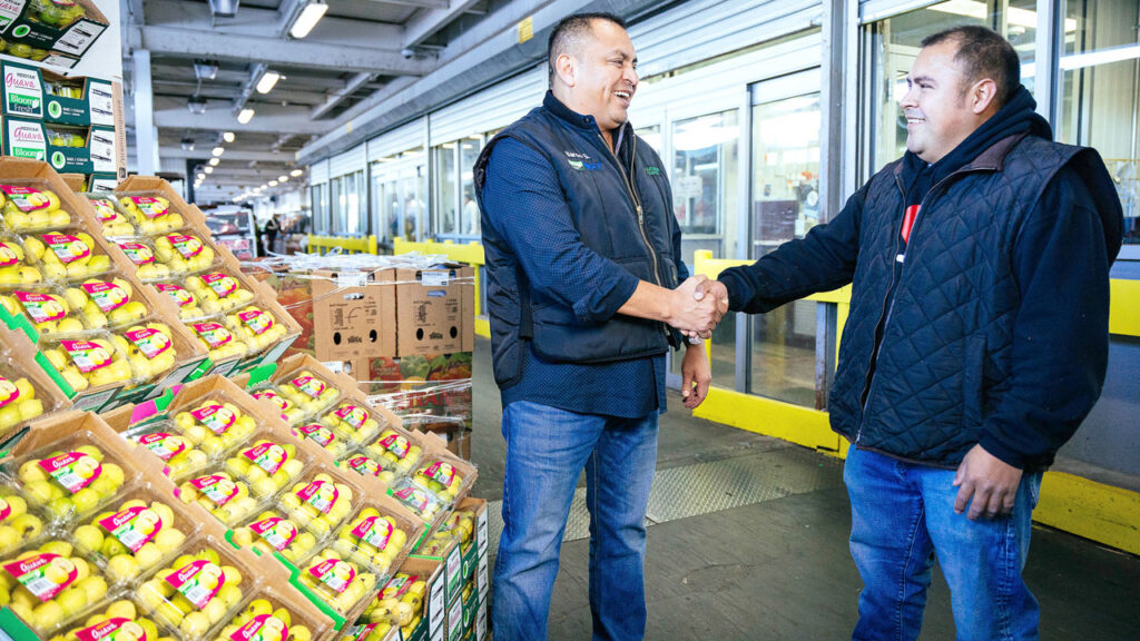 To better serve customers, wholesalers are expanding produce lineups, increasing services and diversifying business to include merchandising, foodservice, distribution and logistics. Pictured, Katzman Produce buyer and salesperson, Bardo Salazar, greets a customer.
