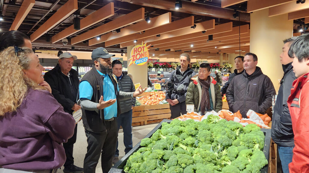 Tour attendees visit the Astor Place Wegmans during the New York Produce Show Manhattan retail tour, exploring the store’s fresh produce offerings and merchandising displays.
